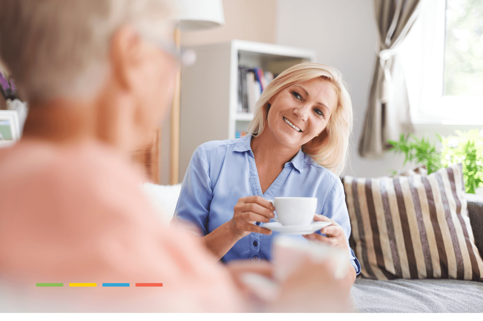 girl holding her cup of coffee while talking nicely to an older lady